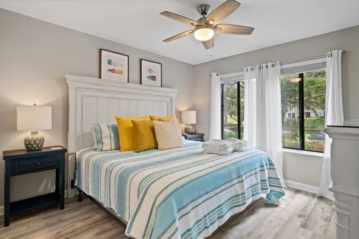 Primary bedroom with large window for natural air.