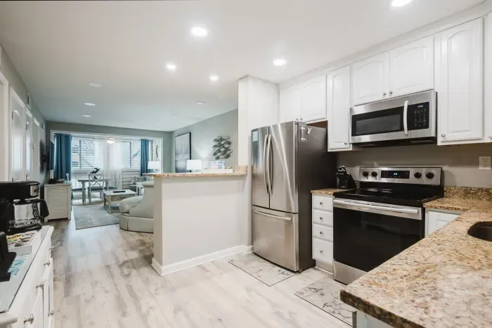 Full kitchen with granite counters and stainless appliances.  Recessed lighting throughout and a layout that keeps the cook connected to the conversation.