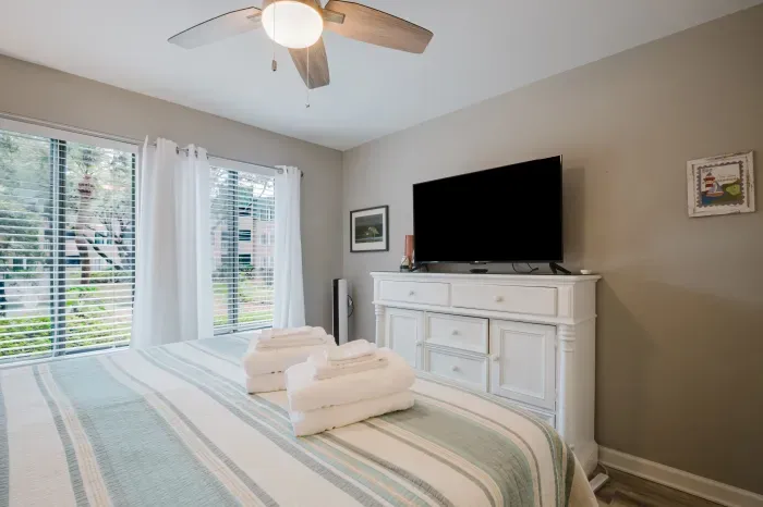 A full dresser for unpacking, a smart TV of your own, and a lagoon view through the sliders. This room earns its "primary" label.