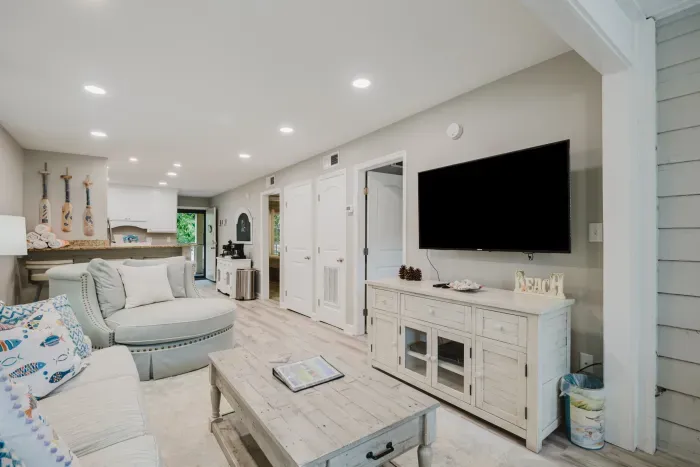 Big smart TV, swivel chair, and sleeper sofa, with both bedrooms and the bath just off the living space. Everything on one level, no stairs inside.