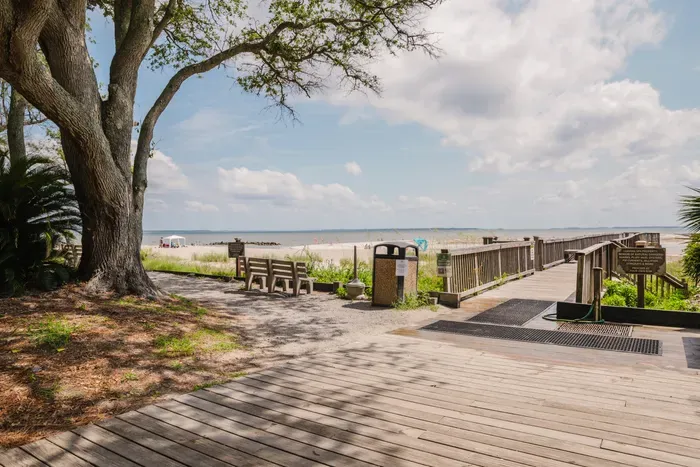 The boardwalk to Fish Haul Beach is steps from your door. Port Royal Sound has a wide tidal range — expect broad sand flats at low tide and a calm, swimmable shoreline as it comes in.