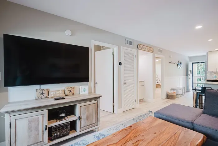 Bright beach-house living room with large TV and airy coastal style