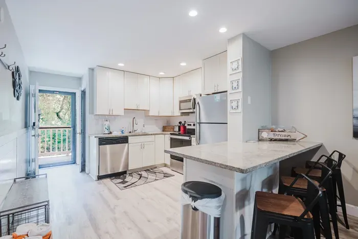 Bright modern kitchen with island seating and easy access to the outdoor deck