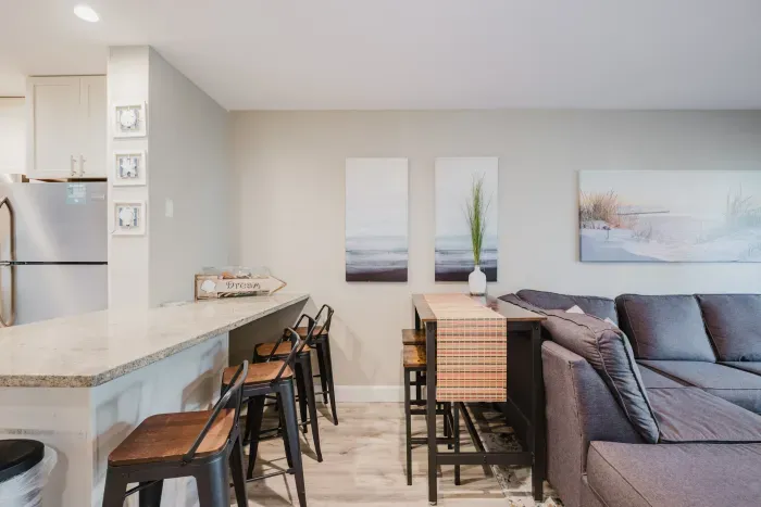 Bright open living area with breakfast bar, dining nook, and cozy seating