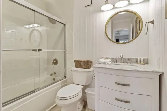 Tub and shower enclosure for the primary bedroom.