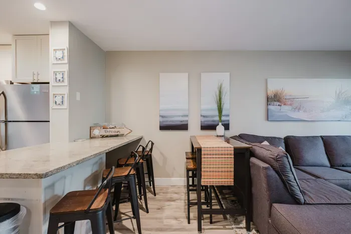 Bright open living area with breakfast bar, dining nook, and cozy seating
