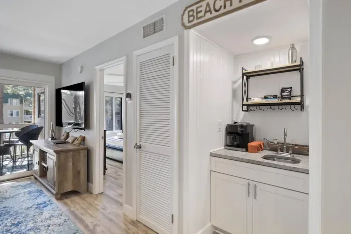 Between coffee bar and  living room