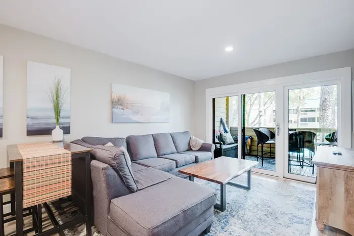 Bright living room with cozy sectional and private patio access