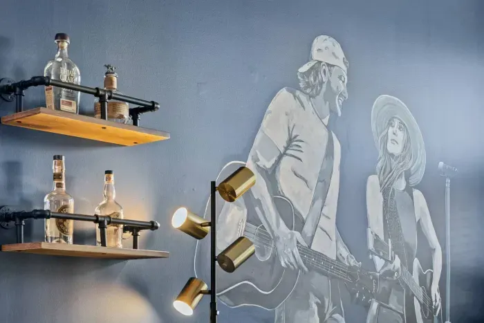 Whiskey bottles resting on the industrial shelving for admiring.