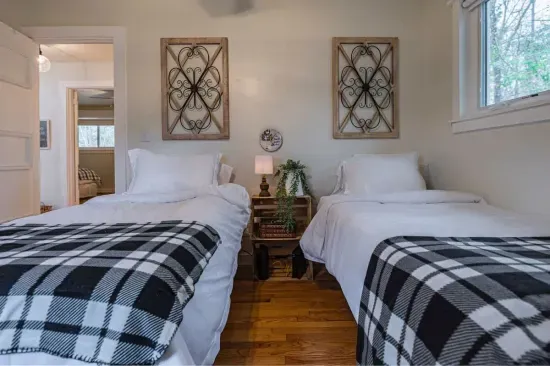 This is the fourth bedroom, featuring two, inviting twin beds. All bedrooms come equipped with a luggage rack, hangers, and an extra set of sheets neatly stored at the top of each closet for your convenience.