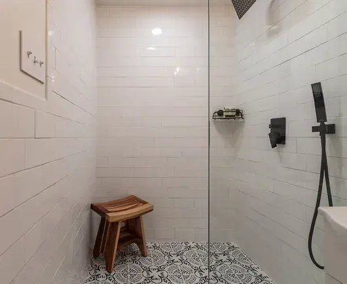 You'll feel pampered in the oversized shower of the split-king Master Suite, tucked privately at the back of the home. With separation from the other three bedrooms, it offers a quiet sanctuary for introverts who crave space to unwind and recharge.