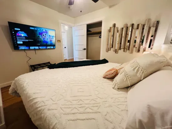 3rd king bedroom has a shared bathroom with one other bedroom in the hallway, next door. This room includes a 55-in tv. 