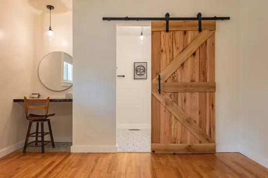 The Master King Suite offers an additional area to get ready in the mornings and this beautiful, heavy barn door. 

The barn door, fireplace mantle and all slab counters in the home were made by Justin Daniel at Daniel's Sawmill in Fayetteville, NC.