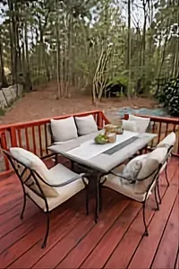 2026: The outdoor deck boasts a patio table with seating for eight total, and nine additional chairs are arranged beside the grill—perfect for gathering around the fire pit.