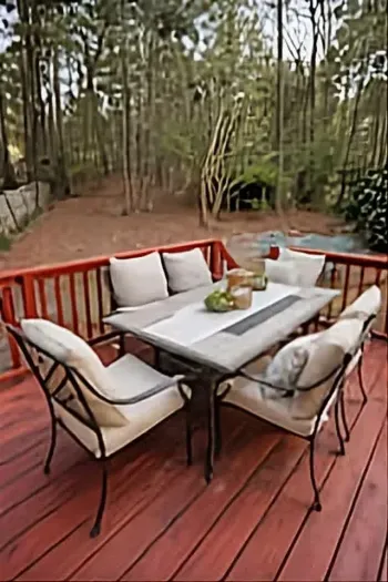 2026: The outdoor deck boasts a patio table with seating for eight total, and nine additional chairs are arranged beside the grill—perfect for gathering around the fire pit.