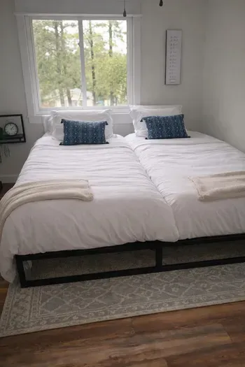Split king bed in bedroom 3 for couples who need their own mattress but want to share a king frame. An en suite bathroom is attached.