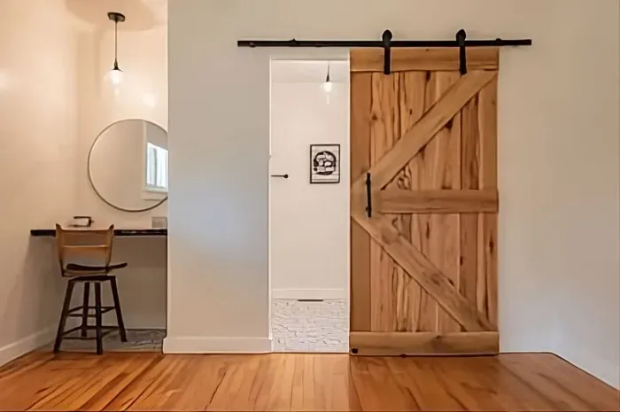 The Master King Suite offers an additional area to get ready in the mornings and this beautiful, heavy barn door. 

The barn door, fireplace mantle and all slab counters in the home were made by Justin Daniel at Daniel's Sawmill in Fayetteville, NC.
