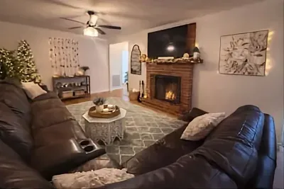 Spacious living room with comfortable seating and smart TV for family gatherings.