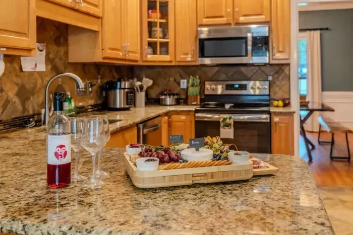 Enjoy this fully stocked kitchen that has three ovens. There is an additional full size fridge in the garage by the 10 foot bar as well.