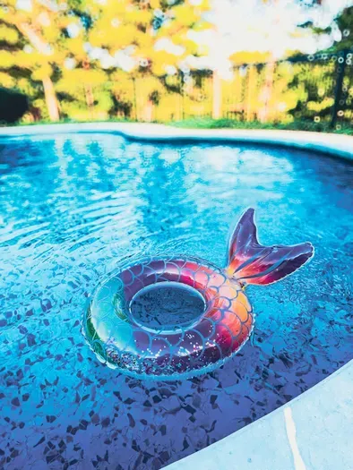Children's sparkly, mermaid float bobbing in the pool. Taken by owner in July 2025. 

*We recommend you bring your own floats.*