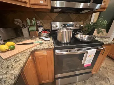 Fully stocked kitchen has 3 ovens with all the cookware and essentials you’ll need to prepare your favorite meals. The photo highlights just a few of the pots and pans available for your use.