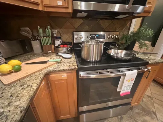 Fully stocked kitchen has 3 ovens with all the cookware and essentials you’ll need to prepare your favorite meals. The photo highlights just a few of the pots and pans available for your use. 