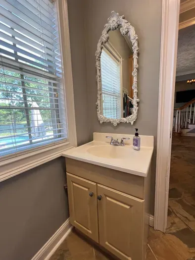 Elegant mirror added to laundry area sink.