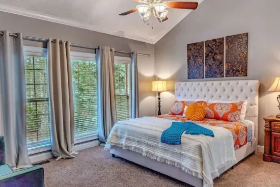 A spacious master suite features a colorful comforter in the spring & summer and thick duvet in fall & winter. This serene, upscale retreat is ideal for relaxation and comfort. 

This bedroom is next to Bedroom 5 , both of which are downstairs. 