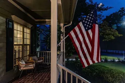 Fort Bragg is 25-30 minutes away! We love our Troops and they are our #1 guests. We feel honored to house them in our community. A welcoming front porch features modern wicker chairs in a cozy nook with bohol cushions, perfect for relaxing.