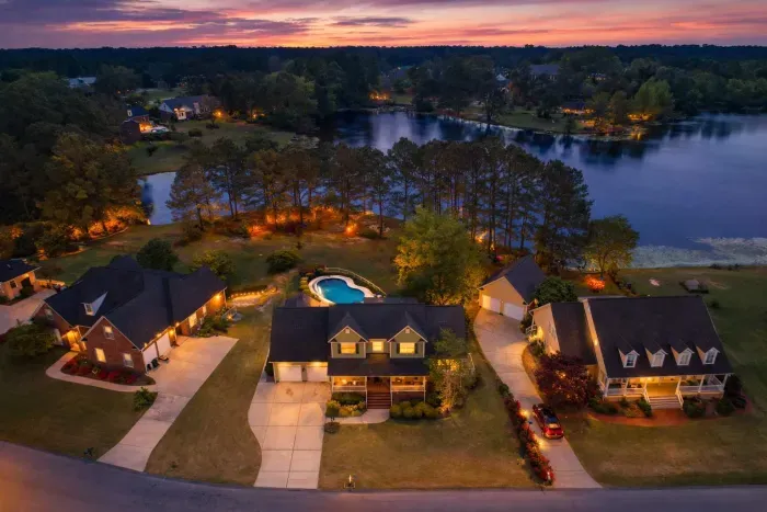 You will enjoy this lake property with a pool! This photo via drone, spring 2025. 
