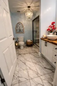 Elegant and serene, the main bathroom features calming décor and a spacious tiled walk-in shower with a built-in bench.