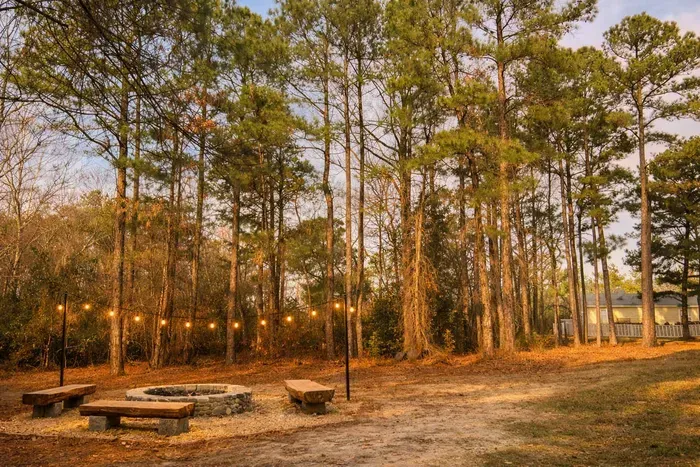 View from hiking trail of bonfire area with back house in the top right corner. Registered guests may enjoy use of this nearby private area during their stay, with prior approval, when it’s not being commercially by owner.