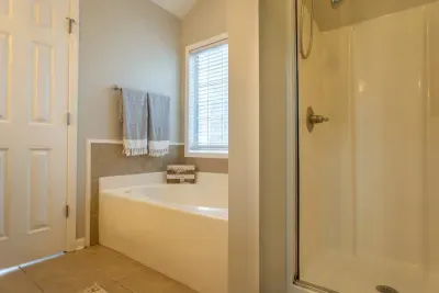 Master bathroom view from walk-in closet. 

Oversized soaking tub feels wonderful after a long day. **Jets currently not working. **