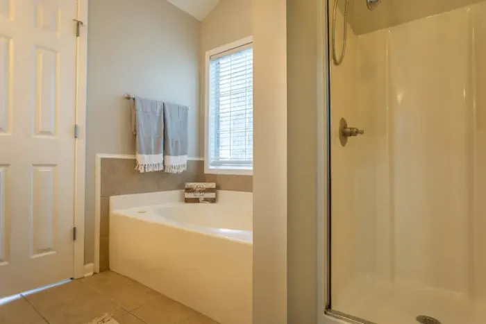 Master bathroom view from walk-in closet. 

Oversized soaking tub feels wonderful after a long day. **Jets currently not working. **