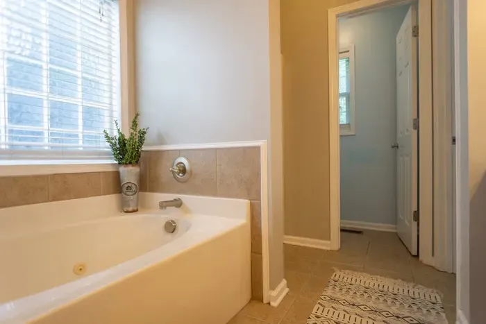 Master king bathroom has an oversized tub and dual vanity with upgraded mirrors. Separate shower is behind bathtub wall. Toliet room is behind shower wall for additional privacy.