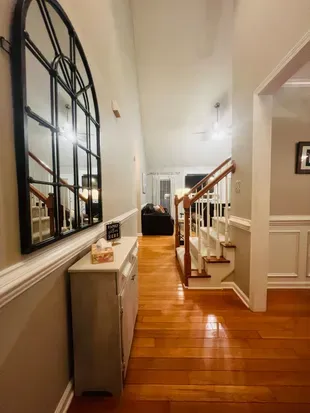 View from front door into house. Dining area to right and living room is past the stairs. The living room and entry area has vaulted ceilings.