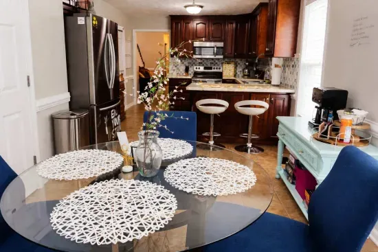 Kitchen nook table viewing into kitchen. Coffee bar on the right. 