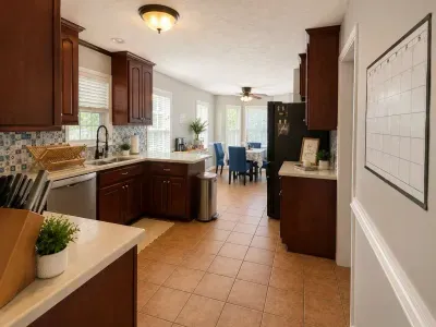 Kitchen view from living room. New stove and refrigerator, May 2026.