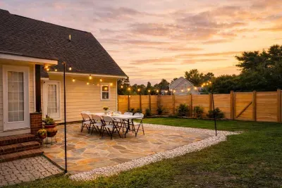 A great house for outdoor fun in the fall or spring! Flagstone patio is 20x20. Grill is not in this picture but in grass to the right off screen. Hanging lights and firepit on the other side of the yard offset the custom privacy fence.