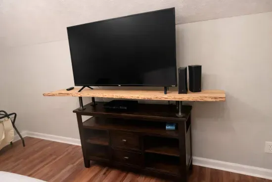 2nd king bedroom view from bed with a 55-in tv. There is also a large writing desk. This bedroom is beside the upstairs bathroom. 