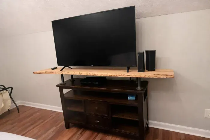 2nd king bedroom view from bed with a 55-in tv. There is also a large writing desk. This bedroom is beside the upstairs bathroom.