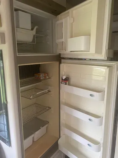 The kitchen features a clean, fully functional retro-style refrigerator — a touch of vintage charm that adds character to your stay.