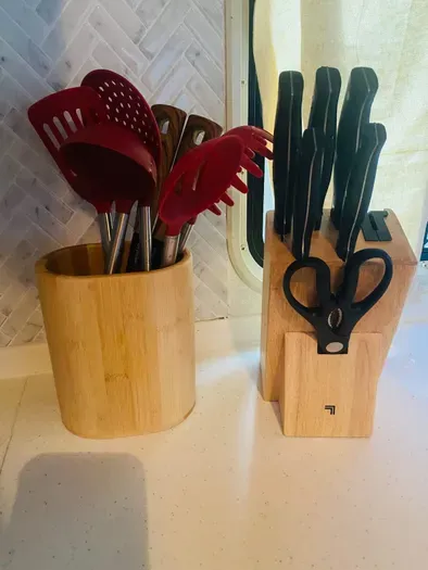 The kitchen is thoughtfully stocked with quality utensils and sharp knives, making it easy to prepare and share meals together.