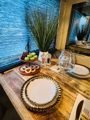 Romantic dining for two — cozy ambiance, soft lighting, and elegant details set the mood for a peaceful meal together. Enjoy wine, laughter, and connection in this thoughtfully designed space.