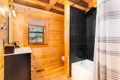 Spacious bathroom with tub shower combo, backlit mirrors and a bluetooth ceiling speaker to listen to music while you bath or get dressed.  