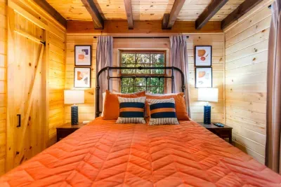 2nd Bedroom complete with queen bed, fan, blackout curtains, roku tv, plenty of closet space and charging port for all your devices.  The hall bath is right outside this bedroom.  