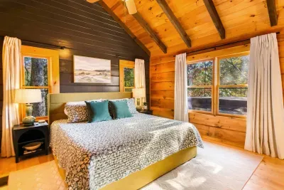 Master bedroom with king bed, charging ports at each bedside table, roku tv, blackout curtains and views of the mountains.  