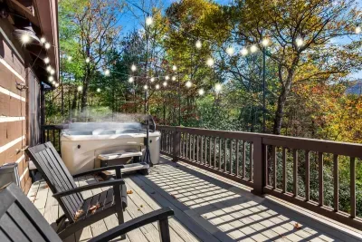 Expansive back deck where you can sit in the hot tub or sit in the Adirondack chairs and watch the sunrise.   