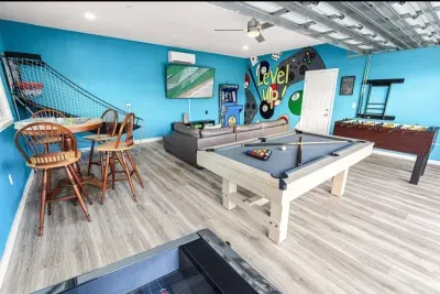 This game room is made for fun nights in with pool, shuffleboard, and space for everyone to hang out together.