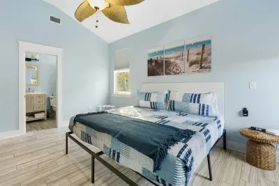 Primary bedroom on the ground level has a king sized bed and ensuite bath for comfort and privacy